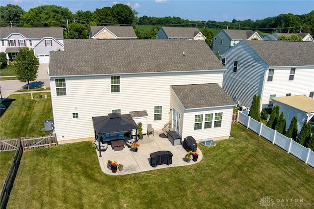 2937 E Ambrosia Ln, Xenia, OH 45385 - back of property featuring a gazebo, a patio, a shingled roof, and a fenced backyard