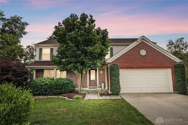 7793 Birchwood Ct, Mason, OH 45040 - view of front of house with concrete driveway, brick siding, a garage, and a yard