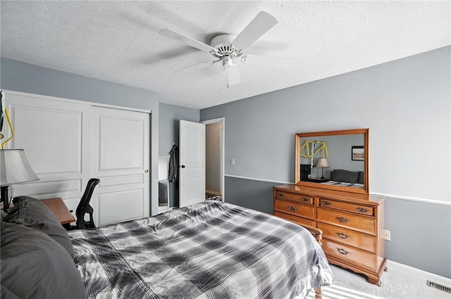 7793 Birchwood Ct, Mason, OH 45040 - bedroom featuring a closet, carpet floors, a textured ceiling, and ceiling fan