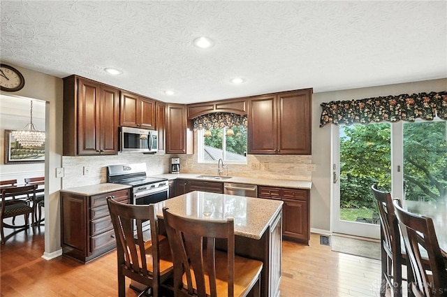 7793 Birchwood Ct, Mason, OH 45040 - kitchen with stainless steel appliances, light wood finished floors, open shelves, tasteful backsplash, and recessed lighting