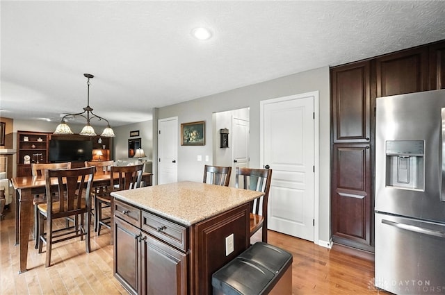 7793 Birchwood Ct, Mason, OH 45040 - kitchen with stainless steel fridge, light wood-style floors, light countertops, and dark brown cabinets