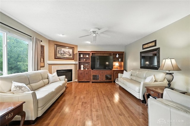 7793 Birchwood Ct, Mason, OH 45040 - living area featuring a ceiling fan, light wood-style floors, and a tile fireplace