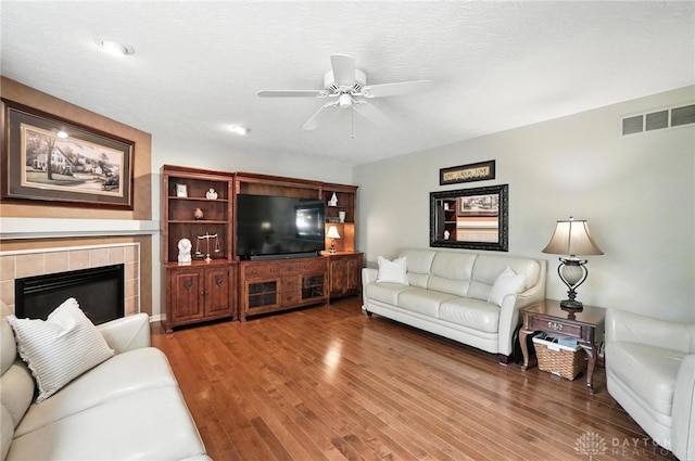 7793 Birchwood Ct, Mason, OH 45040 - living area featuring ceiling fan, wood finished floors, and a tiled fireplace