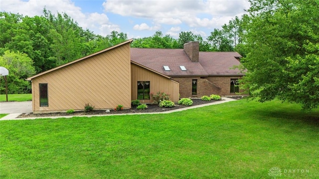 4230 Wagner Rd, Dayton, OH 45440 - mid-century modern home with a chimney and a front lawn