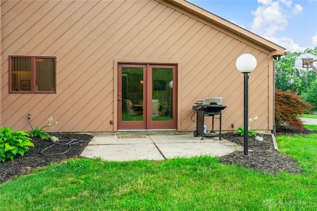 4230 Wagner Rd, Dayton, OH 45440 - view of exterior entry with a patio area and a lawn