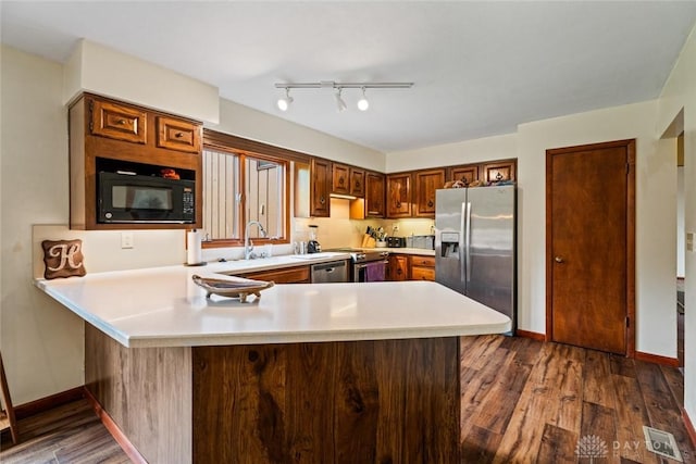 4230 Wagner Rd, Dayton, OH 45440 - kitchen featuring stainless steel refrigerator with ice dispenser, black microwave, light countertops, a peninsula, and dark wood-type flooring