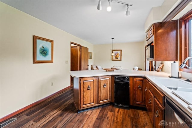 4230 Wagner Rd, Dayton, OH 45440 - kitchen featuring stainless steel dishwasher, a peninsula, dark wood-type flooring, light countertops, and decorative light fixtures
