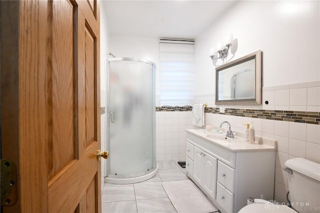 719 N Keowee St, Dayton, OH 45404 - bathroom featuring a stall shower, vanity, tile walls, tile patterned floors, and wainscoting