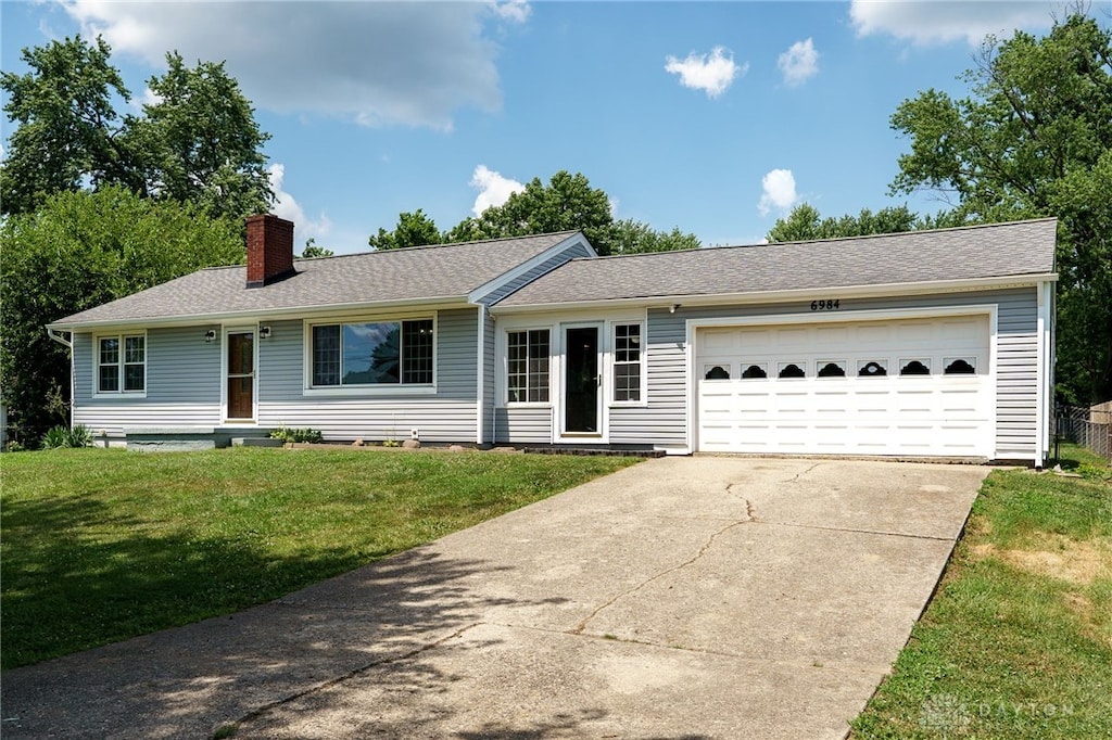 6984 Talton Dr, Middletown, OH 45042 - single story home featuring a chimney, driveway, a front yard, and an attached garage