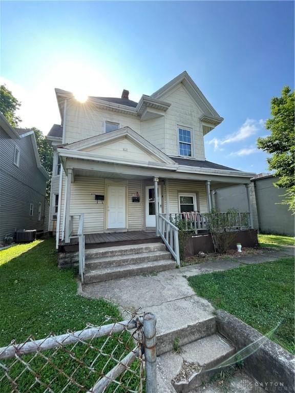 419 Baltimore St, Middletown, OH 45044 - view of front of home featuring a porch, a front yard, and a chimney