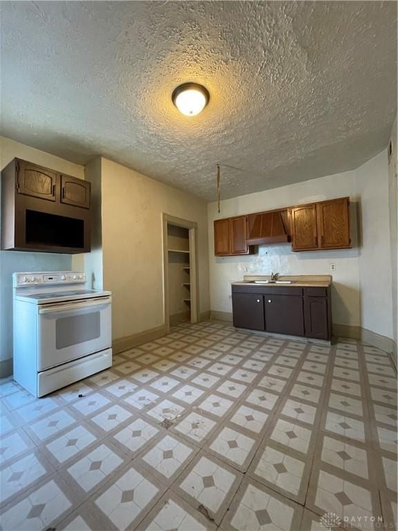 419 Baltimore St, Middletown, OH 45044 - kitchen featuring white range with electric stovetop, a textured ceiling, and light floors