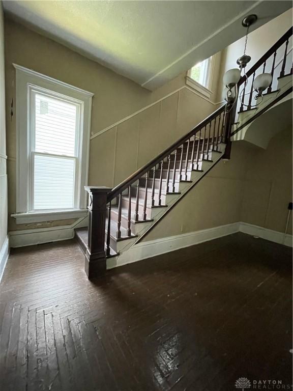 419 Baltimore St, Middletown, OH 45044 - stairway with hardwood / wood-style floors and a chandelier