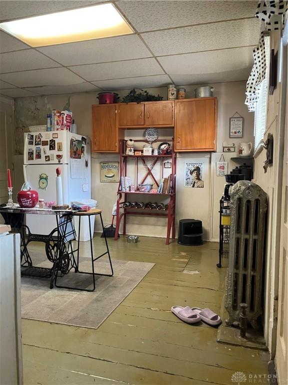 419 Baltimore St, Middletown, OH 45044 - kitchen with light wood-style flooring, freestanding refrigerator, brown cabinets, and a drop ceiling