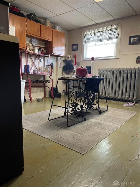 419 Baltimore St, Middletown, OH 45044 - dining room with radiator heating unit, a drop ceiling, and hardwood / wood-style flooring
