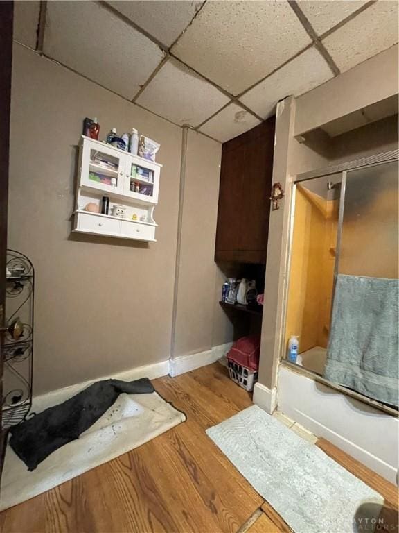 419 Baltimore St, Middletown, OH 45044 - bathroom with a paneled ceiling, wood finished floors, and shower / bath combination with glass door