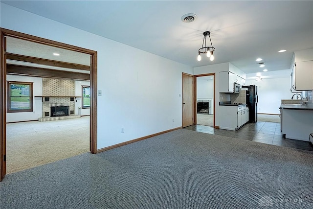 5282 Rahway Ct, Clayton, OH 45415 - unfurnished living room featuring a fireplace, dark colored carpet, and recessed lighting