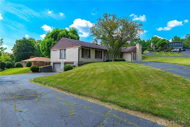 5282 Rahway Ct, Clayton, OH 45415 - single story home featuring a garage, asphalt driveway, a chimney, and a front yard