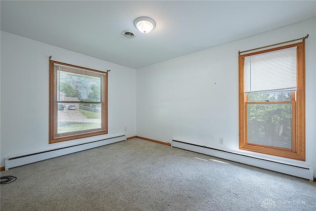 5282 Rahway Ct, Clayton, OH 45415 - carpeted empty room featuring a baseboard heating unit and plenty of natural light