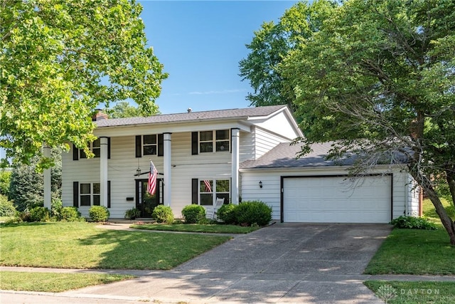 1269 Redbud Dr, Fairborn, OH 45324 - neoclassical / greek revival house featuring concrete driveway, a front lawn, a garage, and a chimney