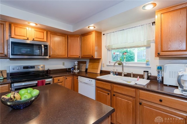 1269 Redbud Dr, Fairborn, OH 45324 - kitchen featuring appliances with stainless steel finishes, dark countertops, recessed lighting, and brown cabinets