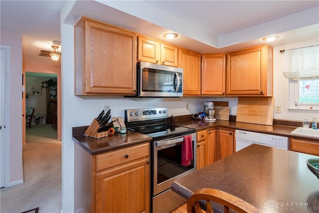 1269 Redbud Dr, Fairborn, OH 45324 - kitchen featuring appliances with stainless steel finishes, dark countertops, light colored carpet, and recessed lighting