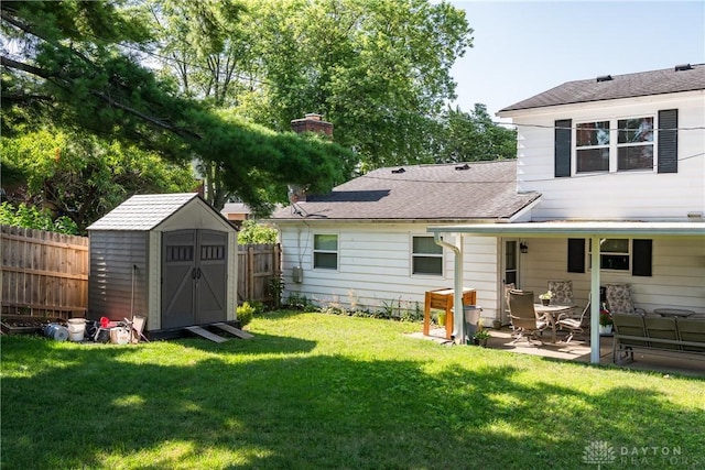 1269 Redbud Dr, Fairborn, OH 45324 - rear view of house featuring a shed, a fenced backyard, a patio, and a shingled roof