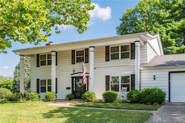 1269 Redbud Dr, Fairborn, OH 45324 - greek revival inspired property with a front yard, a garage, and a chimney