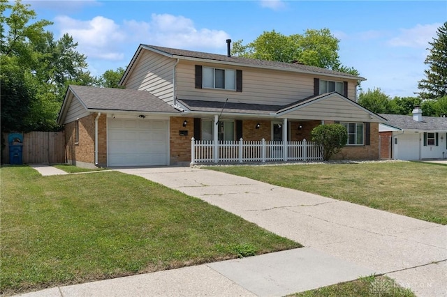 5433 Pentland Cir, Huber Heights, OH 45424 - traditional-style home with brick siding, a garage, concrete driveway, and a porch