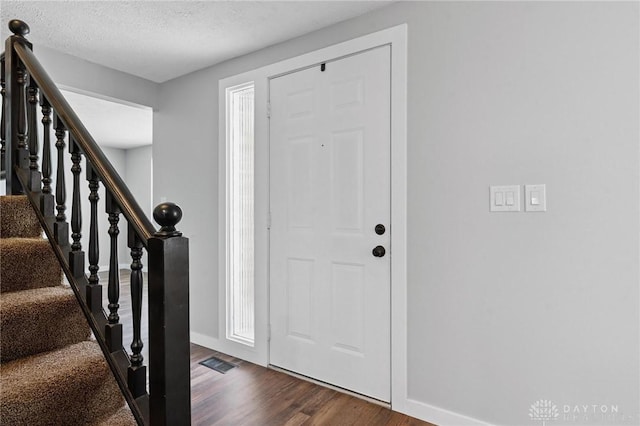 5433 Pentland Cir, Huber Heights, OH 45424 - foyer entrance featuring dark wood-style flooring, stairway, and a textured ceiling