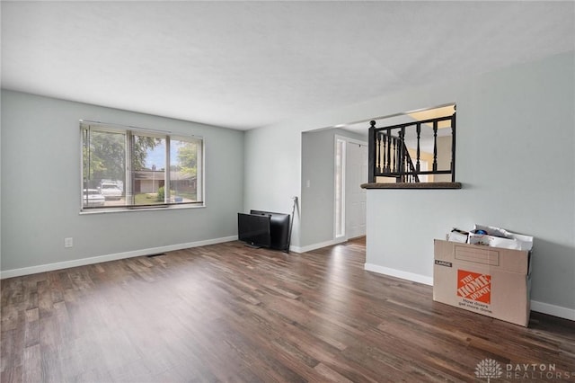5433 Pentland Cir, Huber Heights, OH 45424 - unfurnished living room featuring dark wood-style flooring and stairway