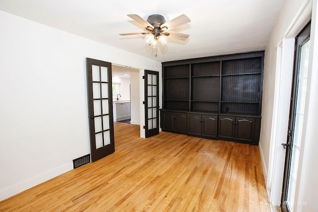 1151 Brookview Ave, Dayton, OH 45409 - unfurnished room featuring light wood-style flooring, ceiling fan, and french doors