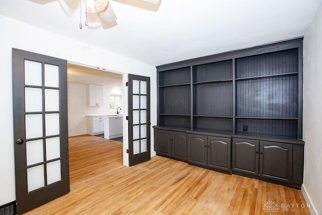1151 Brookview Ave, Dayton, OH 45409 - unfurnished room with light wood finished floors, a ceiling fan, and french doors