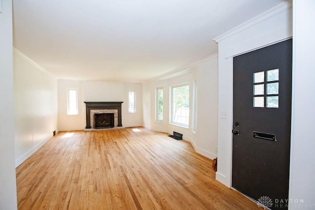 1151 Brookview Ave, Dayton, OH 45409 - unfurnished living room with light wood-style floors, ornamental molding, and a fireplace with raised hearth