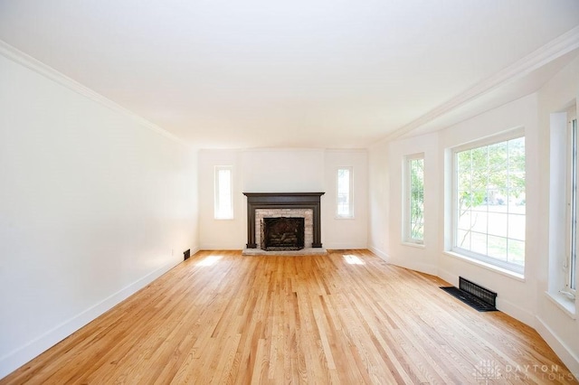 1151 Brookview Ave, Dayton, OH 45409 - unfurnished living room with plenty of natural light, ornamental molding, light wood-type flooring, and a fireplace with raised hearth