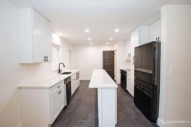 1151 Brookview Ave, Dayton, OH 45409 - kitchen with black appliances, white cabinetry, dark wood-type flooring, recessed lighting, and light stone counters