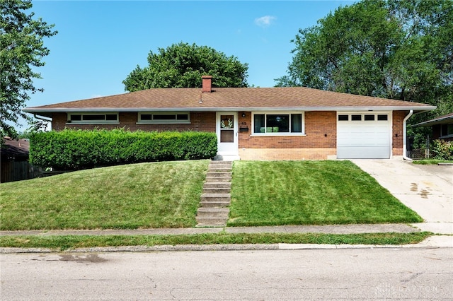 57 Pollyanna Ave, Germantown, OH 45327 - ranch-style house with brick siding, an attached garage, a front lawn, driveway, and a chimney