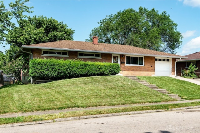 57 Pollyanna Ave, Germantown, OH 45327 - single story home featuring a chimney, brick siding, a garage, a front lawn, and concrete driveway