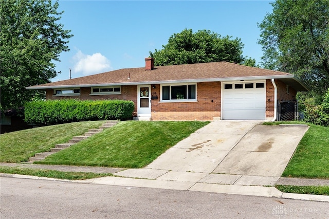 57 Pollyanna Ave, Germantown, OH 45327 - ranch-style home with brick siding, a chimney, a garage, and concrete driveway