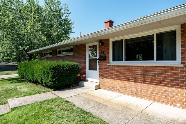 57 Pollyanna Ave, Germantown, OH 45327 - view of front of house featuring brick siding, a chimney, and a front lawn