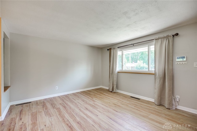 57 Pollyanna Ave, Germantown, OH 45327 - spare room featuring wood finished floors and a textured ceiling
