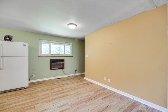 57 Pollyanna Ave, Germantown, OH 45327 - empty room with a wall mounted AC and light wood-style flooring