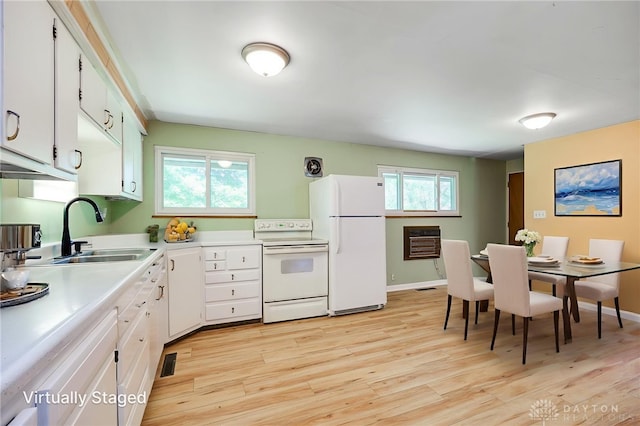57 Pollyanna Ave, Germantown, OH 45327 - kitchen with white appliances, light wood-style flooring, light countertops, white cabinets, and heating unit