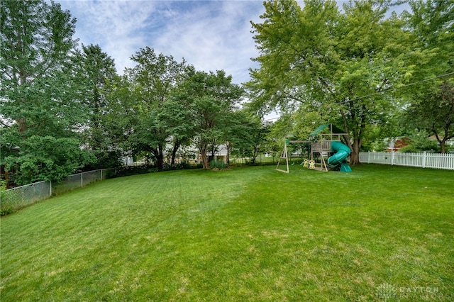 338 Chatham Dr, Fairborn, OH 45324 - fenced backyard featuring a playground