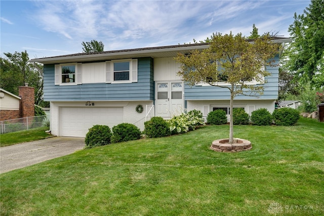 338 Chatham Dr, Fairborn, OH 45324 - bi-level home with concrete driveway, brick siding, and a garage