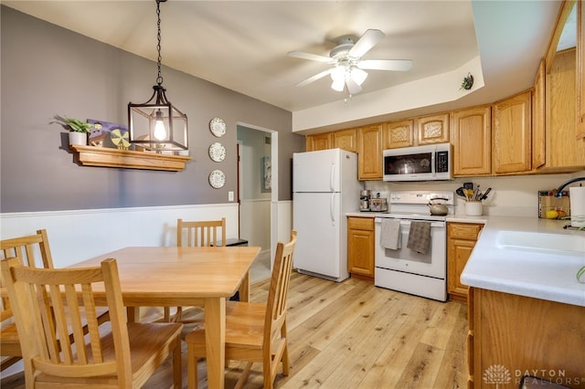 338 Chatham Dr, Fairborn, OH 45324 - kitchen featuring white appliances, a ceiling fan, light countertops, light wood-style flooring, and wainscoting