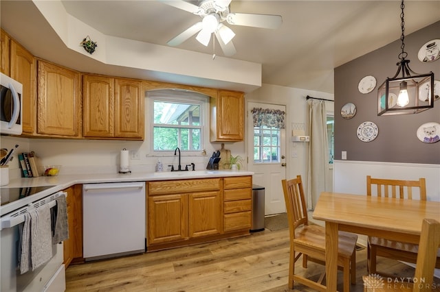338 Chatham Dr, Fairborn, OH 45324 - kitchen with white appliances, light wood finished floors, light countertops, ceiling fan, and decorative light fixtures