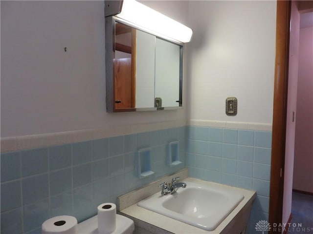2830 Kennedy Ave, Dayton, OH 45420 - half bath featuring tile walls, vanity, and wainscoting