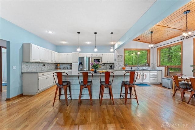 10370 Old 3c Hwy, Clarksville, OH 45113 - kitchen with appliances with stainless steel finishes, tasteful backsplash, white cabinetry, and a chandelier