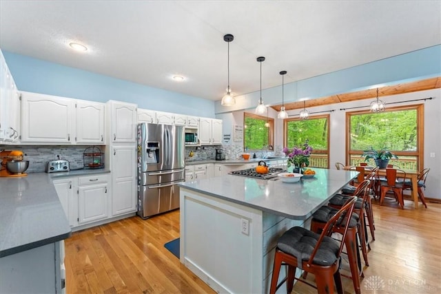 10370 Old 3c Hwy, Clarksville, OH 45113 - kitchen with appliances with stainless steel finishes, light wood-style flooring, tasteful backsplash, and white cabinetry