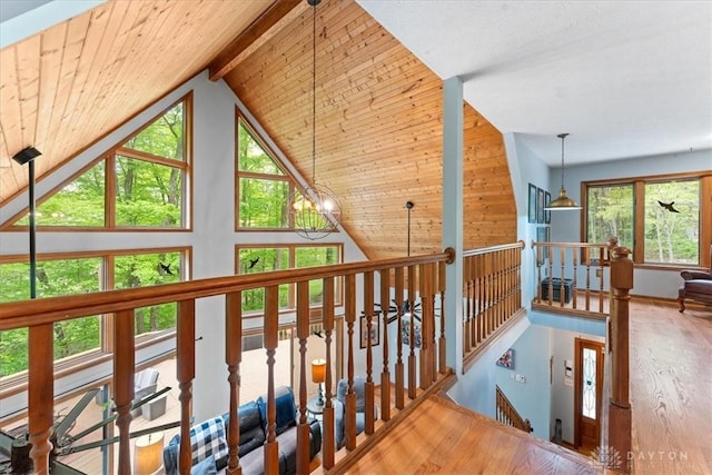 10370 Old 3c Hwy, Clarksville, OH 45113 - hallway featuring an upstairs landing, wood finished floors, beam ceiling, high vaulted ceiling, and a chandelier